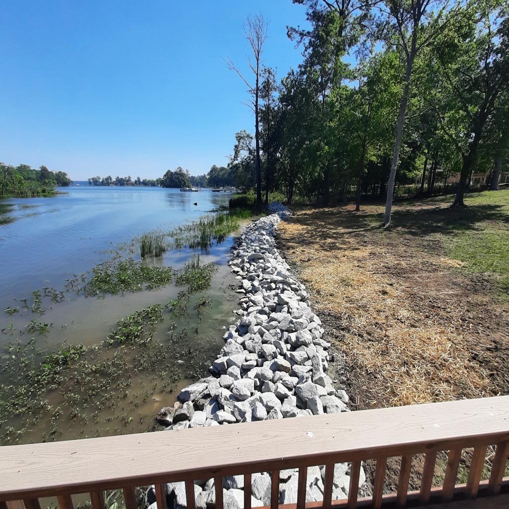 A nice and clean, well managed shoreline with a rock wall installed.